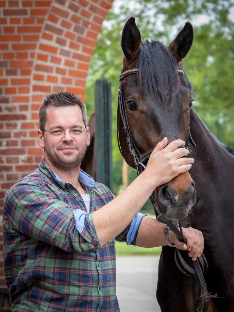 Pferdetierarzt Quentin Rehra mit einem braunen Pferd